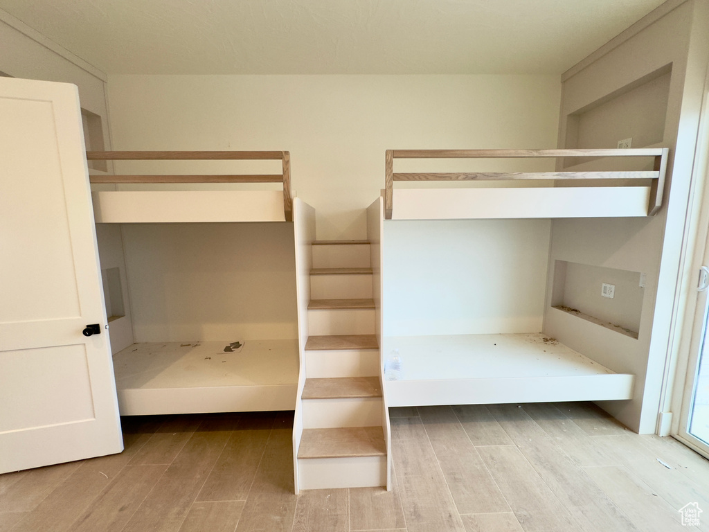 Unfurnished bedroom featuring light wood-type flooring