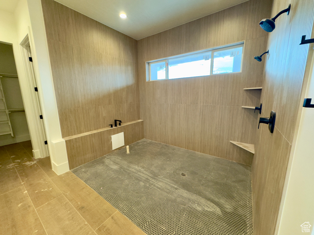 Bathroom featuring tile patterned flooring and tiled shower