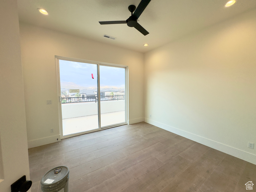 Empty room featuring light wood-type flooring and ceiling fan