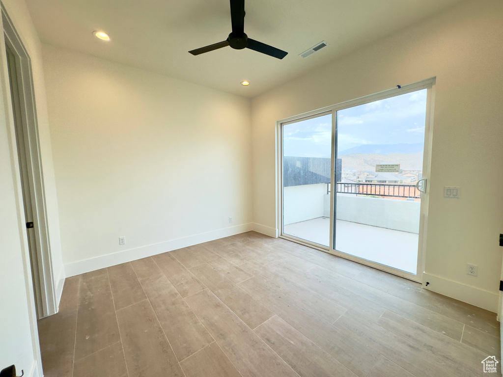 Spare room featuring ceiling fan, a mountain view, and light hardwood / wood-style floors