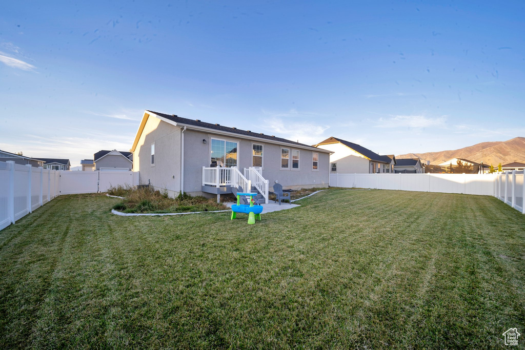 Rear view of house with a yard