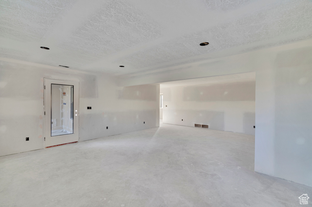 Unfurnished room featuring a textured ceiling