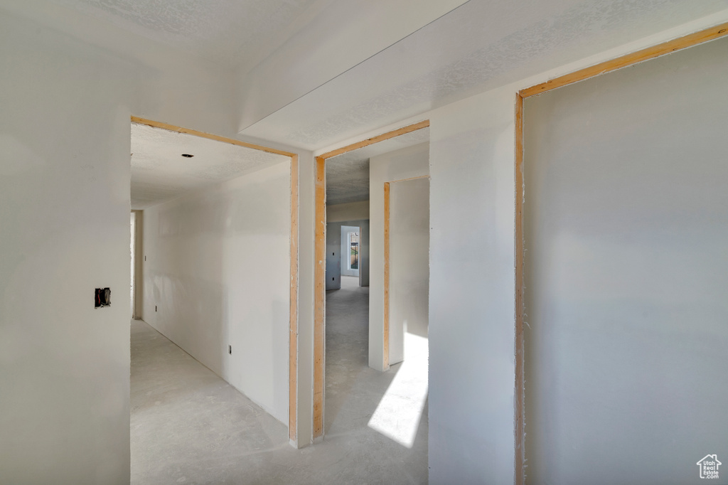 Hallway featuring a textured ceiling