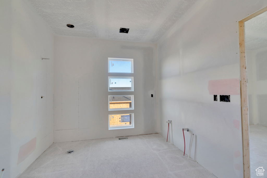 Unfurnished room with a textured ceiling