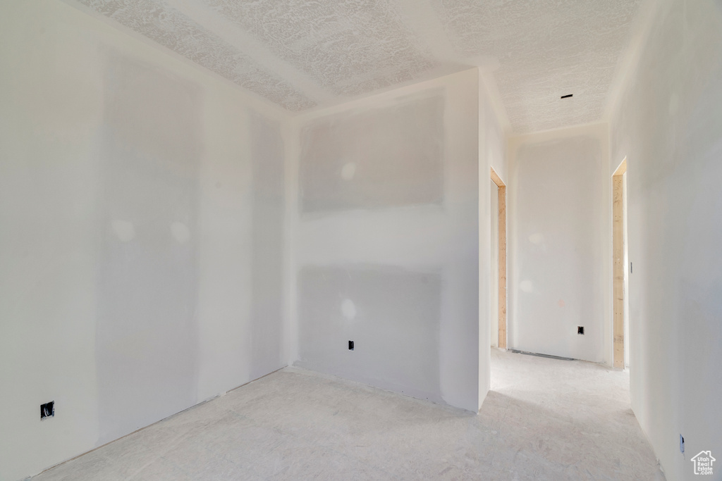 Unfurnished room featuring a textured ceiling