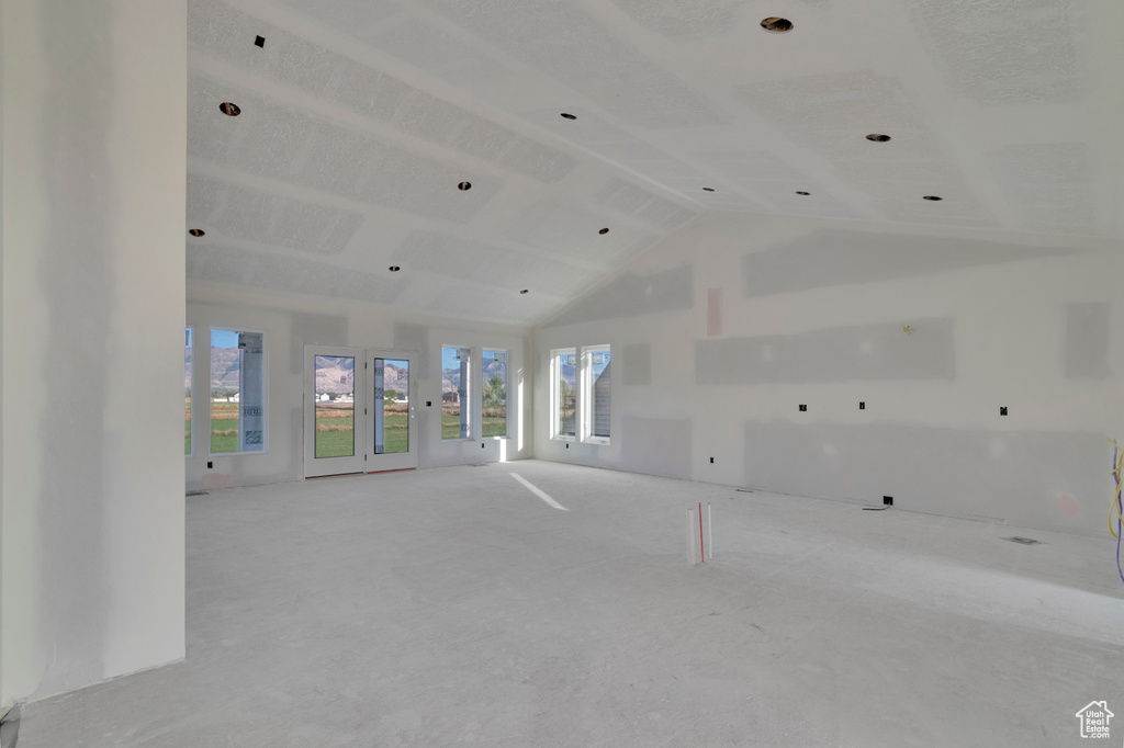 Empty room with lofted ceiling