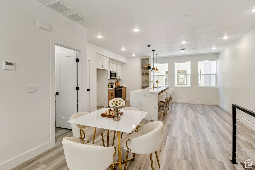 Dining area with light wood-type flooring