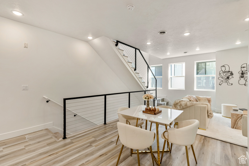 Dining space with light hardwood / wood-style flooring