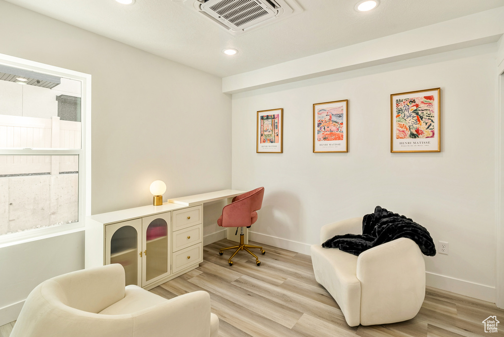 Office area featuring built in desk and light wood-type flooring