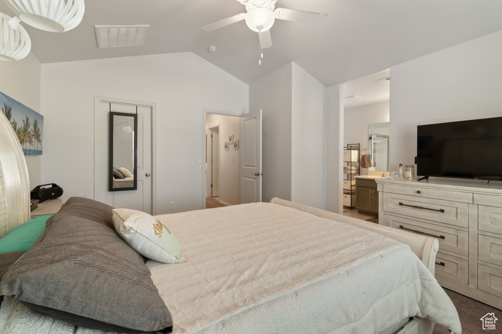 Carpeted bedroom featuring lofted ceiling, ceiling fan, and connected bathroom