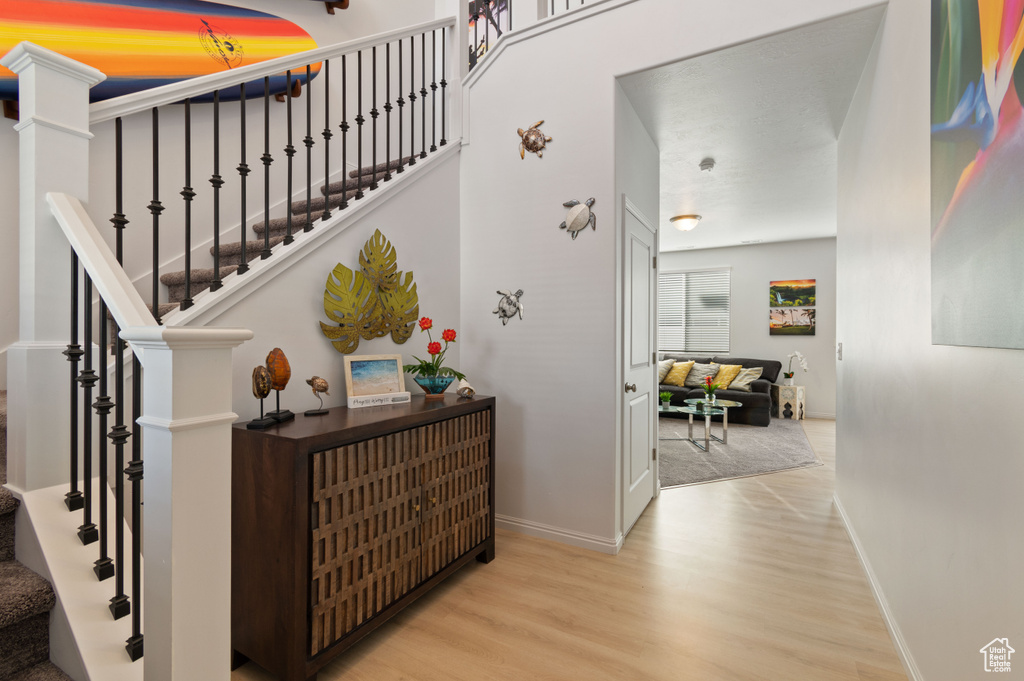 Staircase featuring wood-type flooring