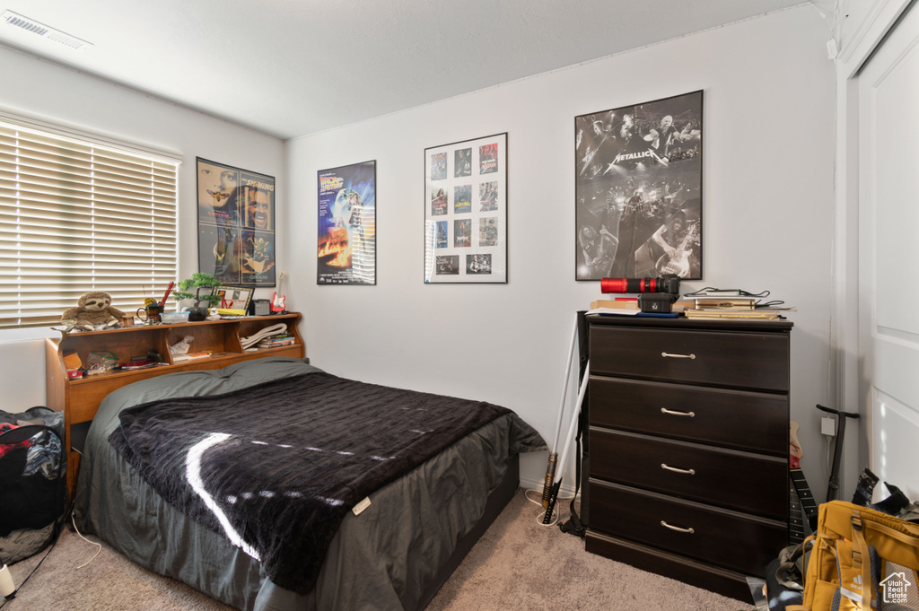 Bedroom featuring light colored carpet