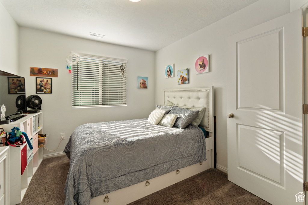 Bedroom featuring dark carpet