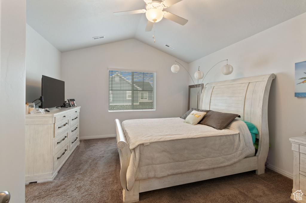 Bedroom with ceiling fan, vaulted ceiling, and carpet