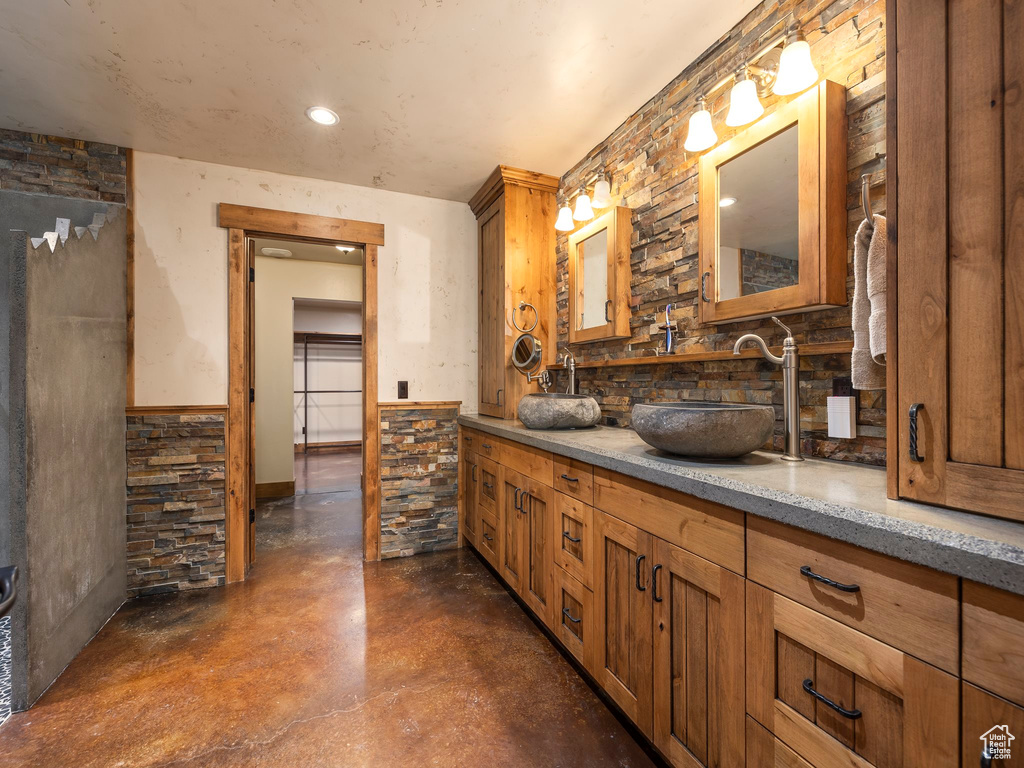 Bathroom with vanity and concrete floors