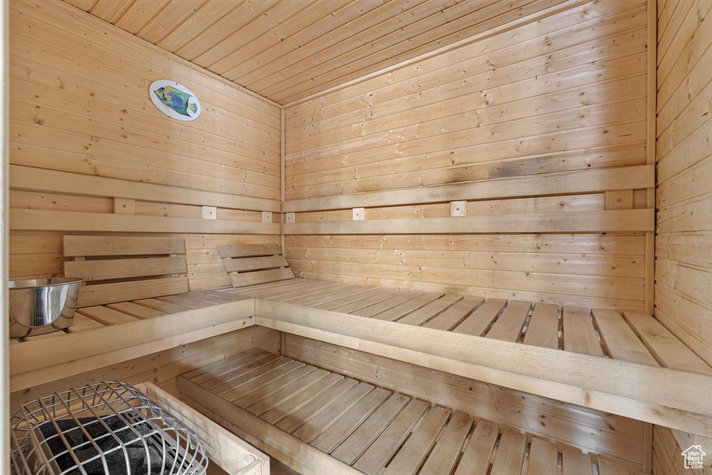 View of sauna featuring wood walls and wood ceiling