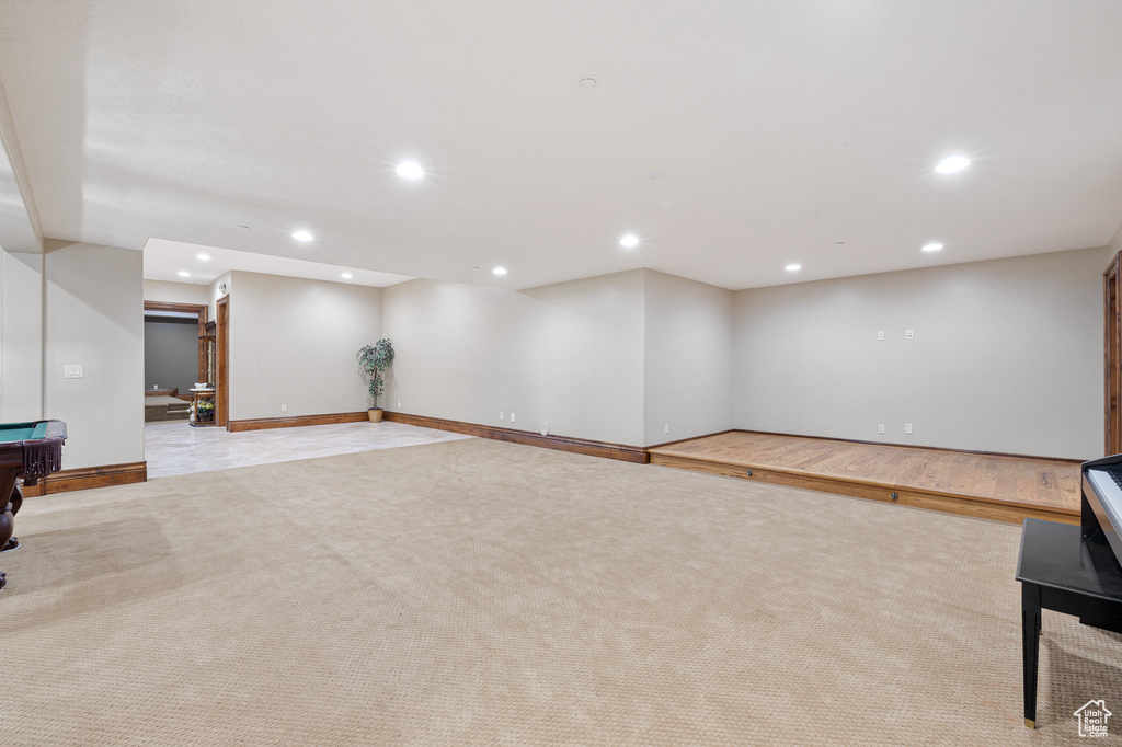 Basement with light colored carpet and billiards