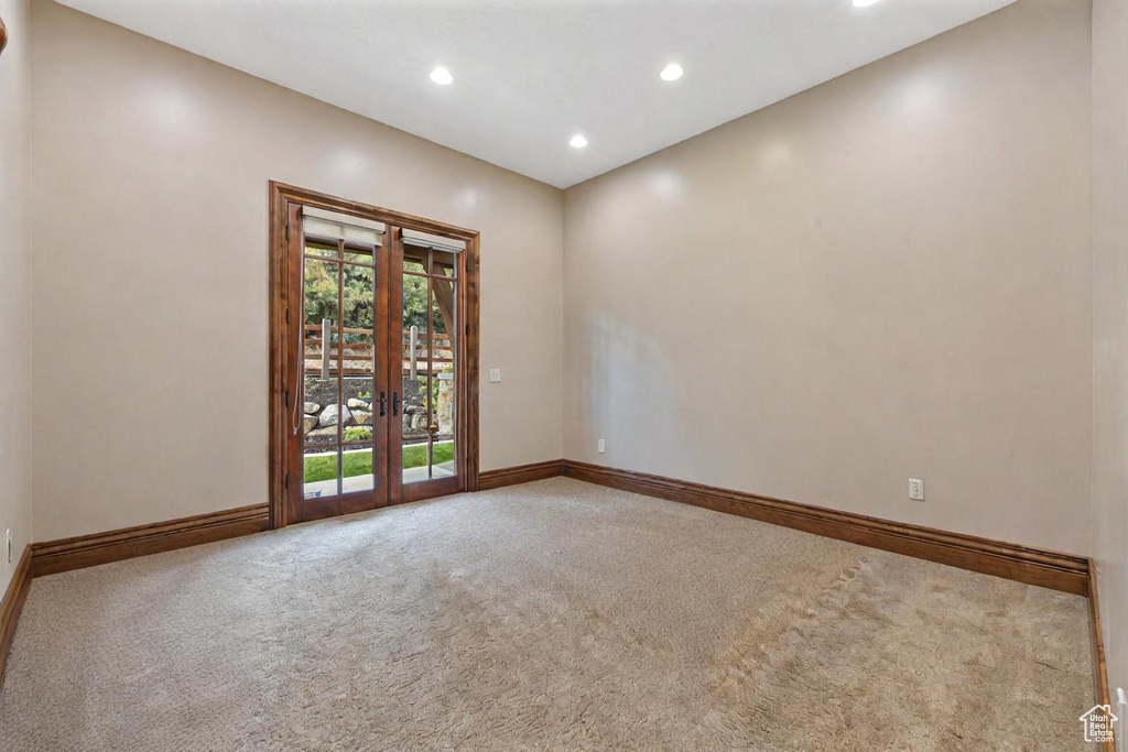 Unfurnished room with french doors and carpet