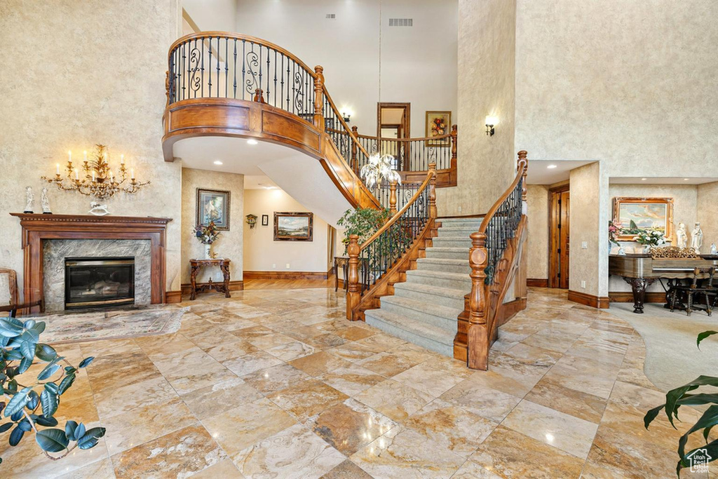 Entryway featuring a high ceiling and a fireplace