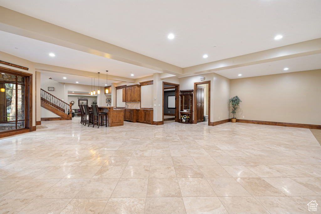 Kitchen featuring a kitchen breakfast bar, hanging light fixtures, and a center island