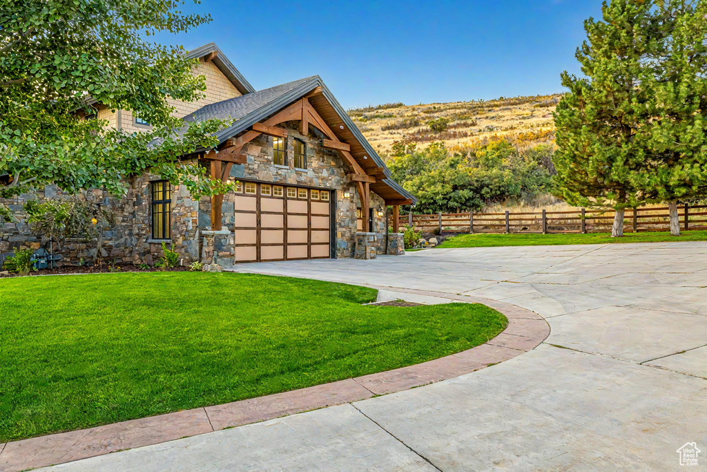 View of side of property with a garage and a yard