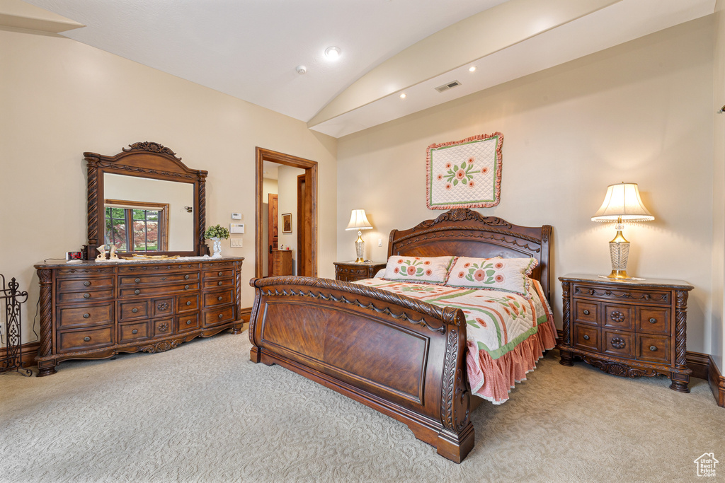 Bedroom featuring lofted ceiling and carpet floors