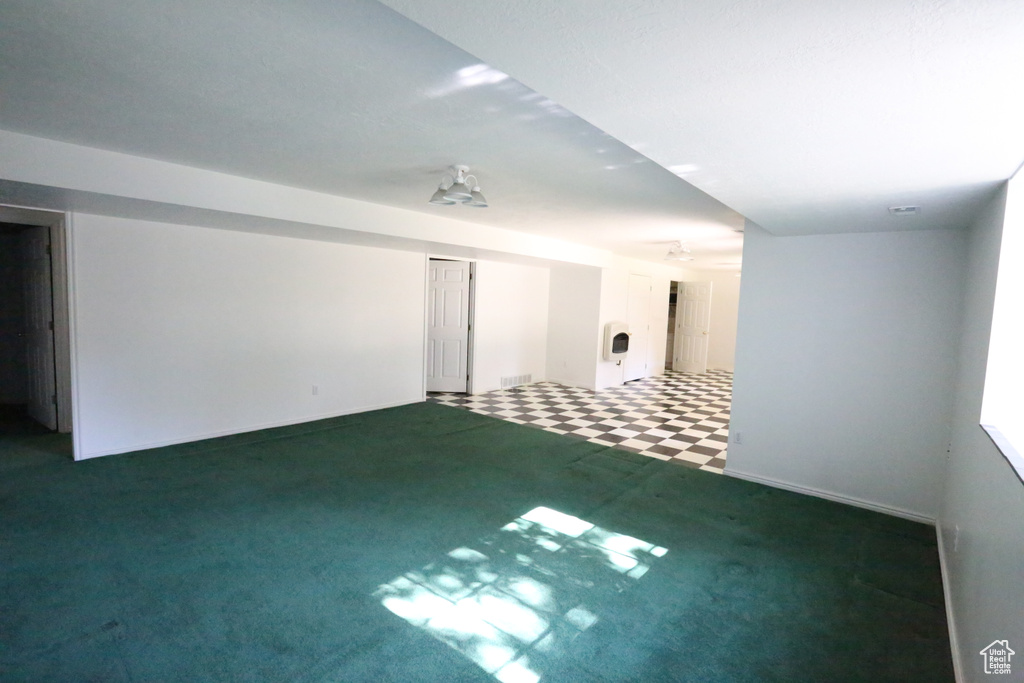 Unfurnished room with dark colored carpet