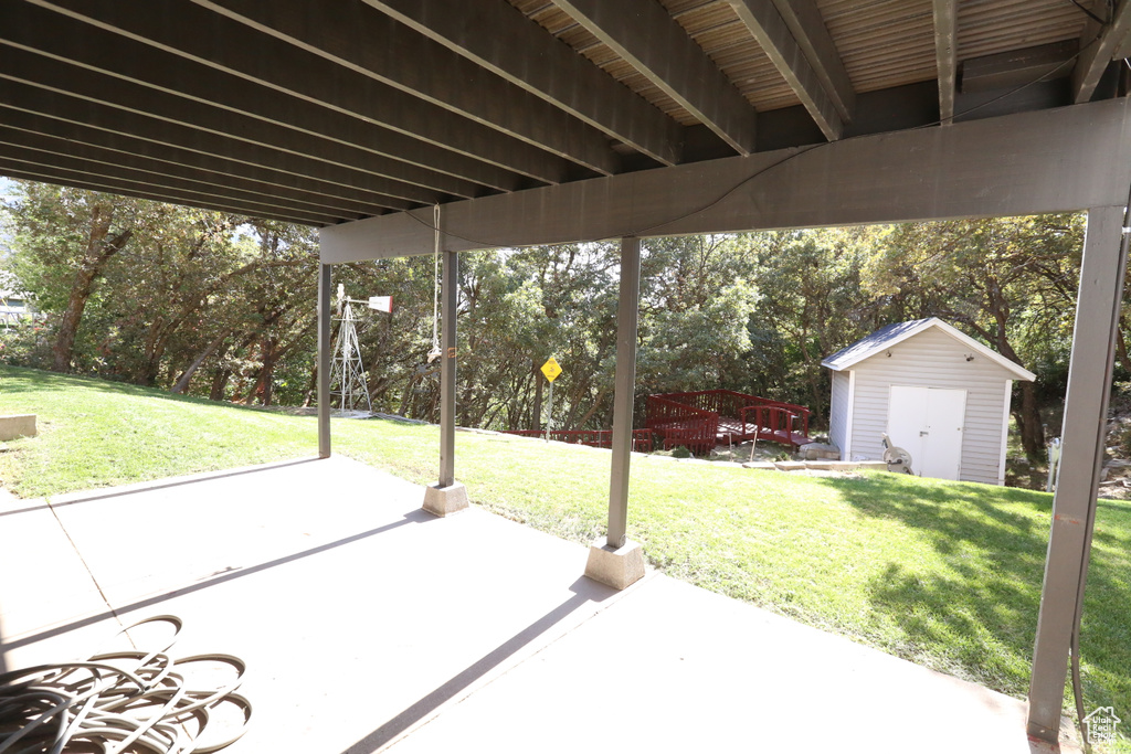 View of patio featuring a storage shed