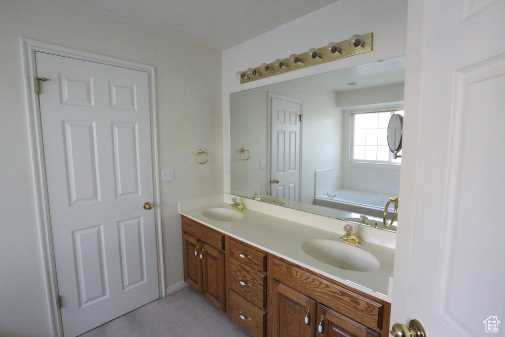 Bathroom featuring a bathtub and vanity