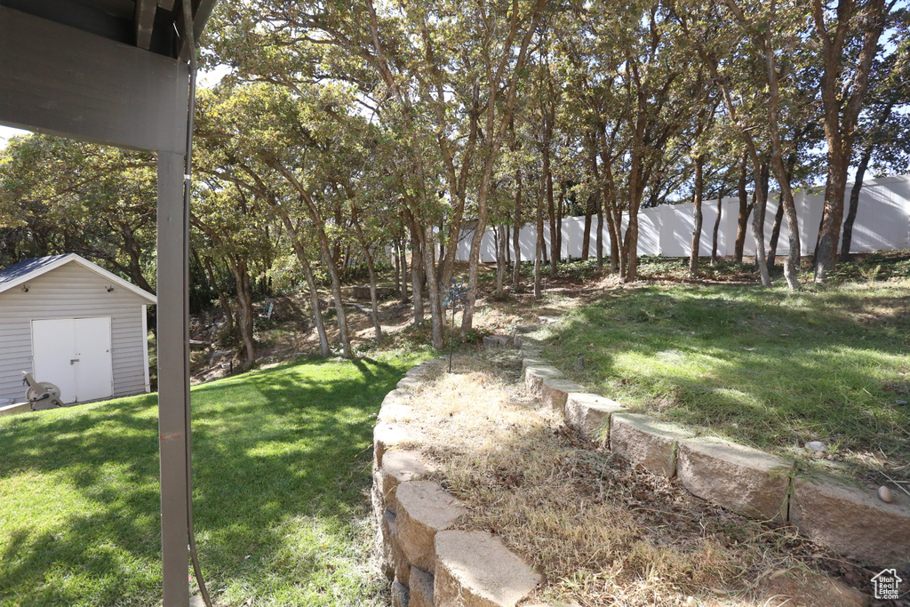 View of yard featuring a storage unit