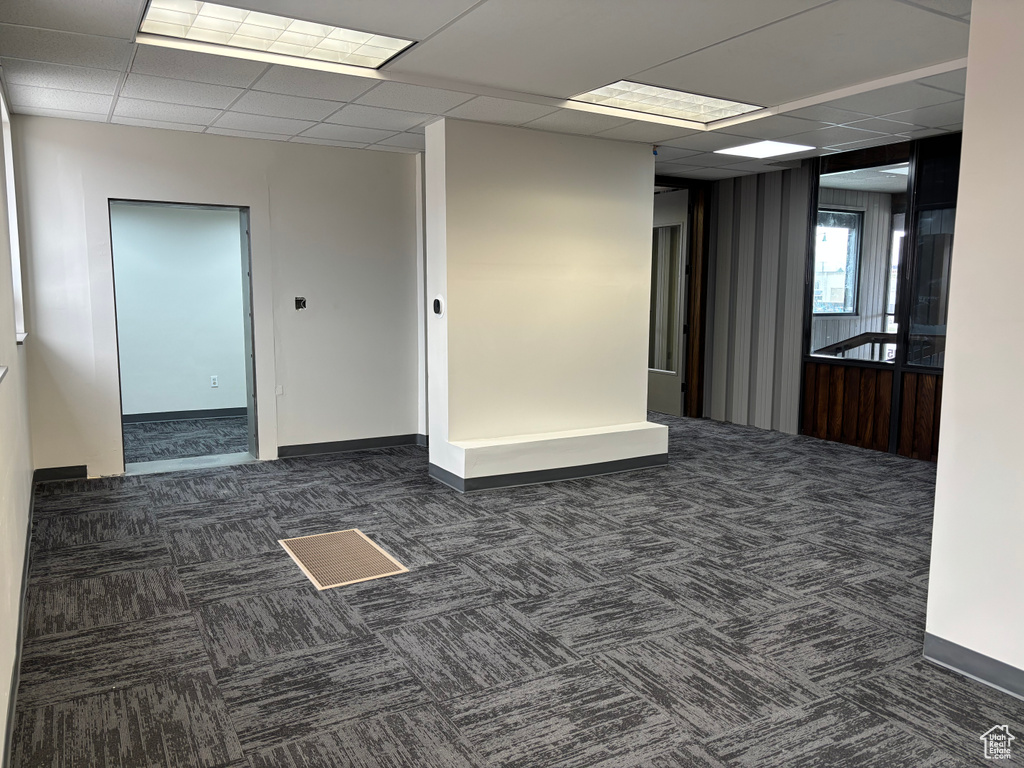 Spare room with baseboards, carpet flooring, and a paneled ceiling