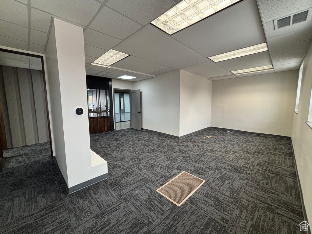 Interior space featuring baseboards, visible vents, and a paneled ceiling