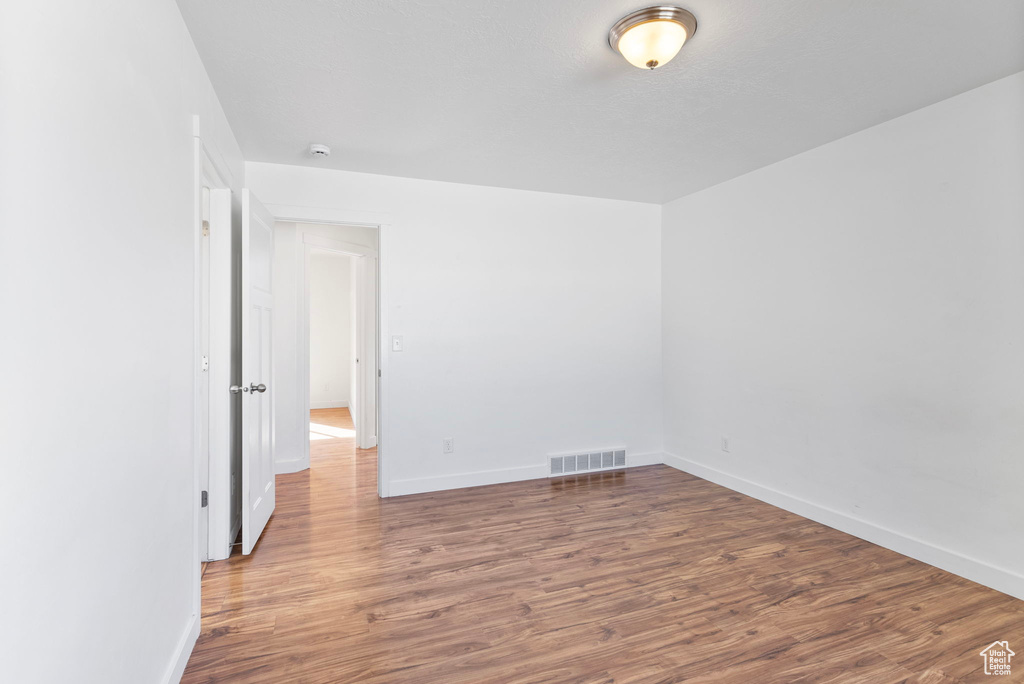 Spare room with wood-type flooring