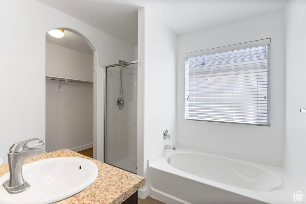 Bathroom featuring independent shower and bath and vanity