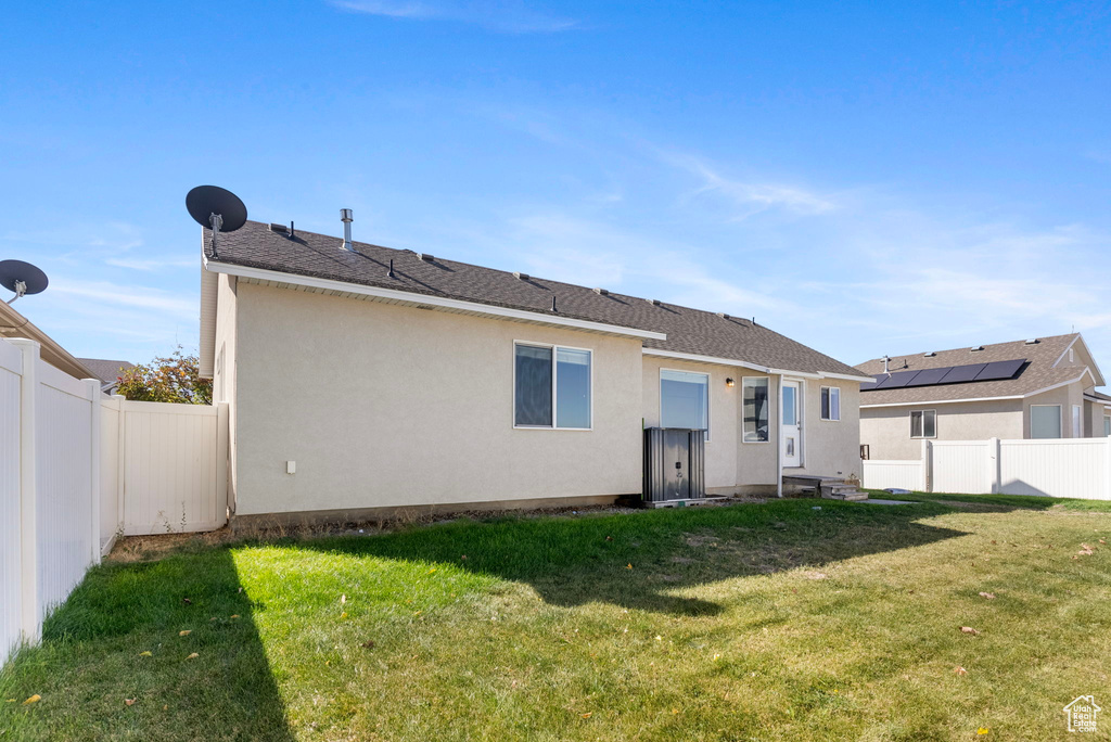 Back of house featuring a lawn