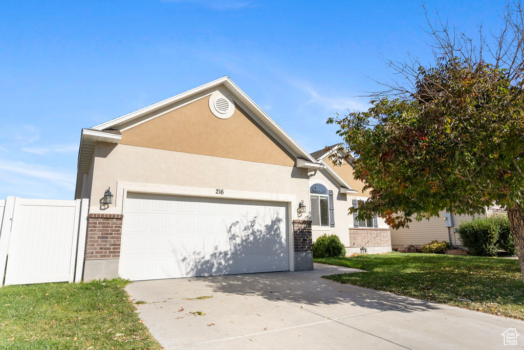 View of front of home featuring a garage and a front yard