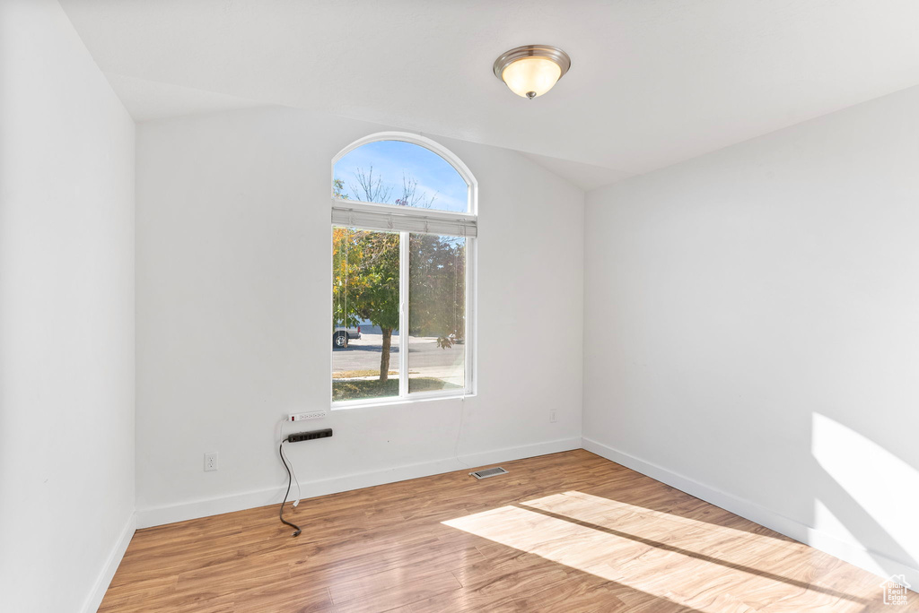 Empty room with light hardwood / wood-style flooring