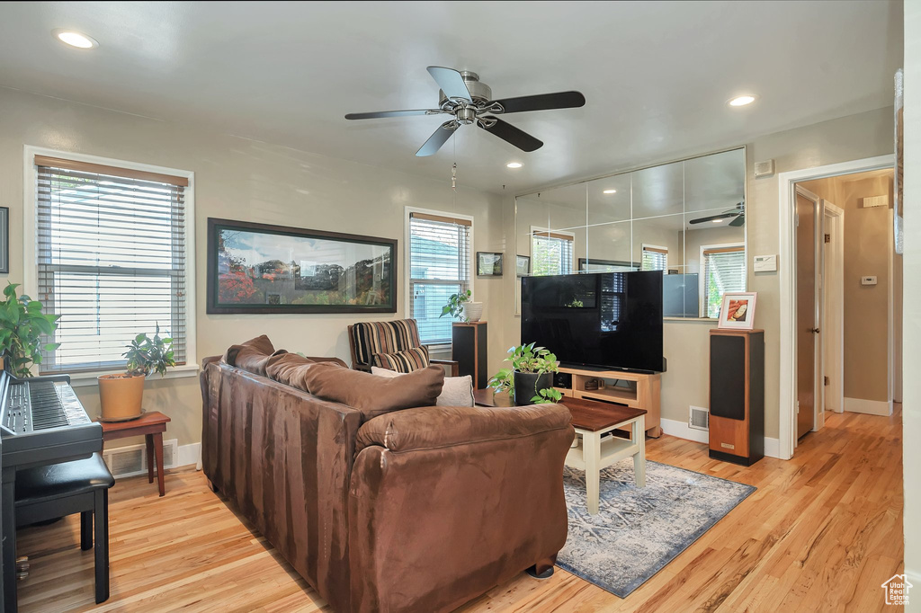 Living room featuring light hardwood / wood-style flooring and ceiling fan