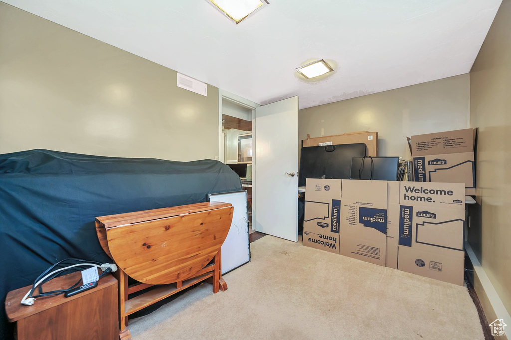 Bedroom with light colored carpet