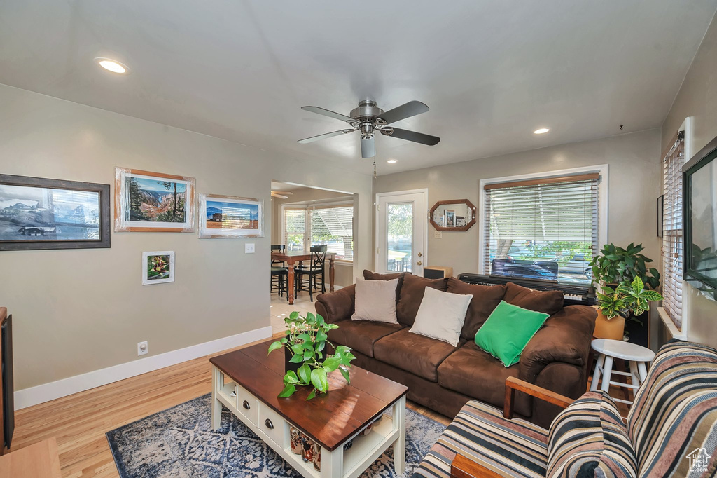 Living room featuring ceiling fan and light hardwood / wood-style floors