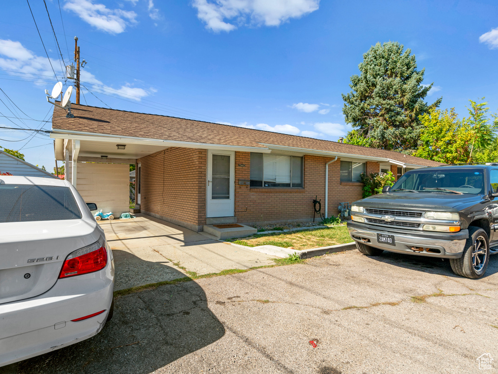 Ranch-style house featuring a carport