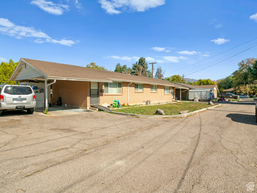 Ranch-style home featuring a carport