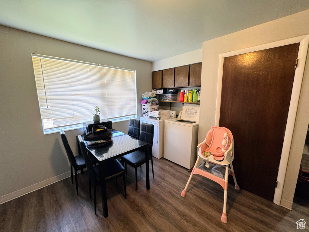 Dining space with dark wood-type flooring and washer and clothes dryer