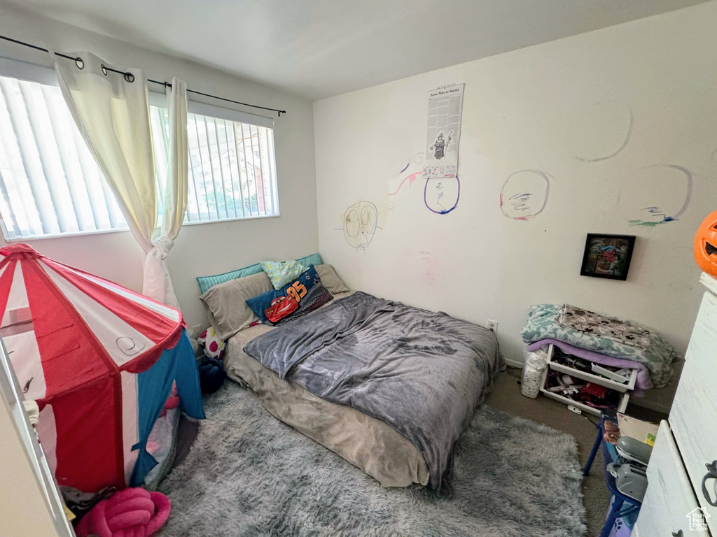 Bedroom with dark colored carpet