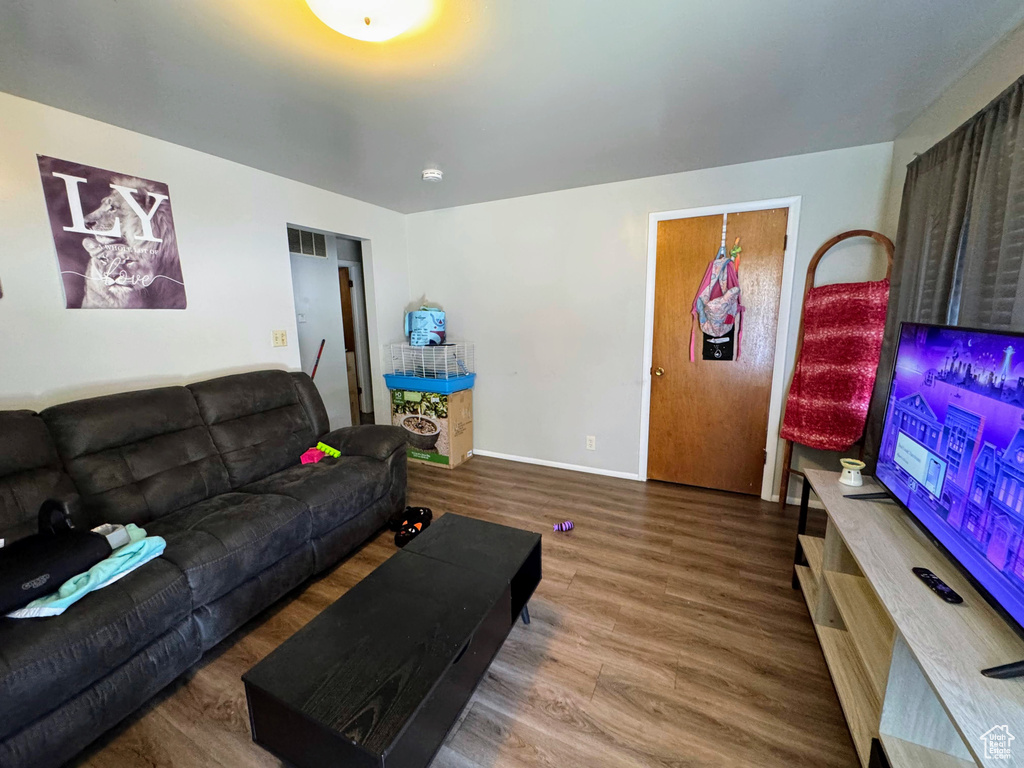 Living room with wood-type flooring