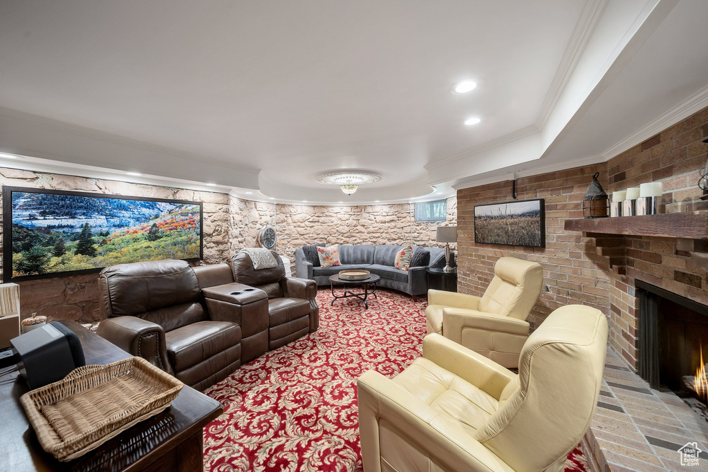 Cinema room featuring crown molding and a fireplace