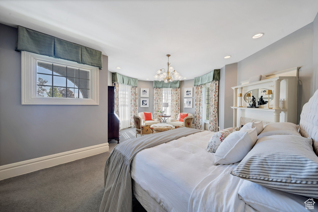 Bedroom with a chandelier and carpet