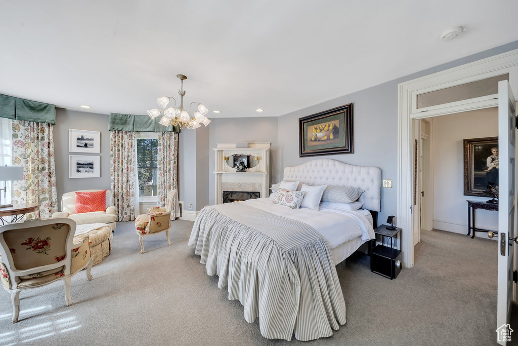 Carpeted bedroom with a chandelier