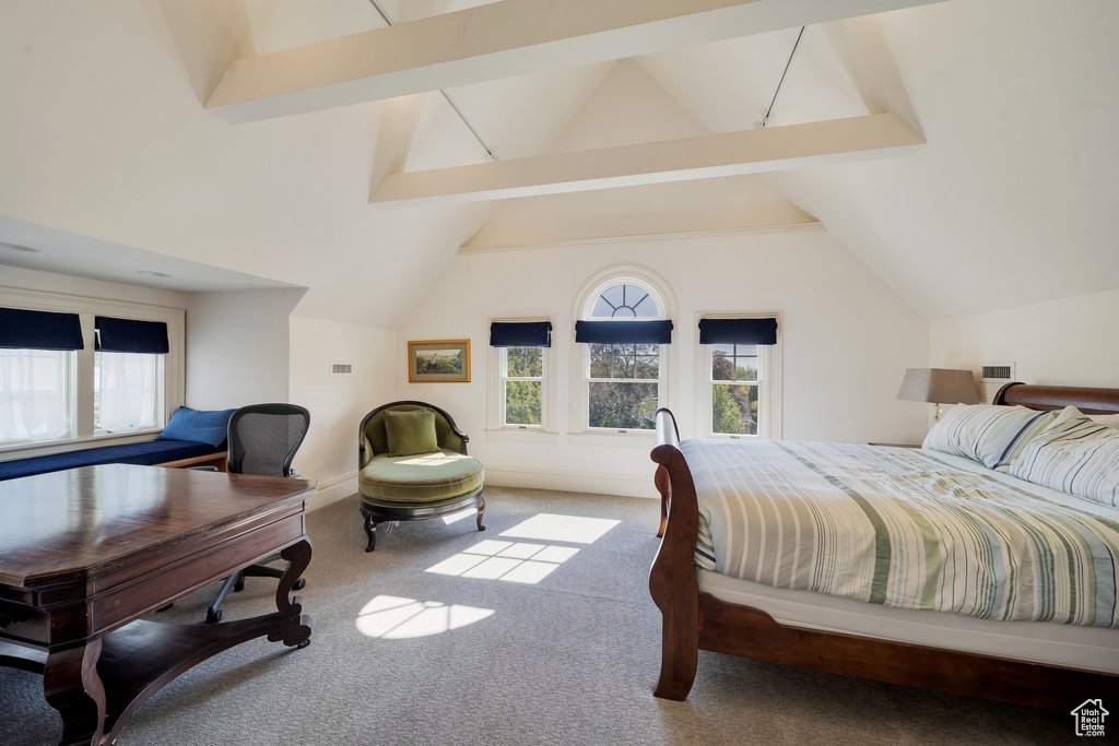 Bedroom with light carpet and vaulted ceiling with beams