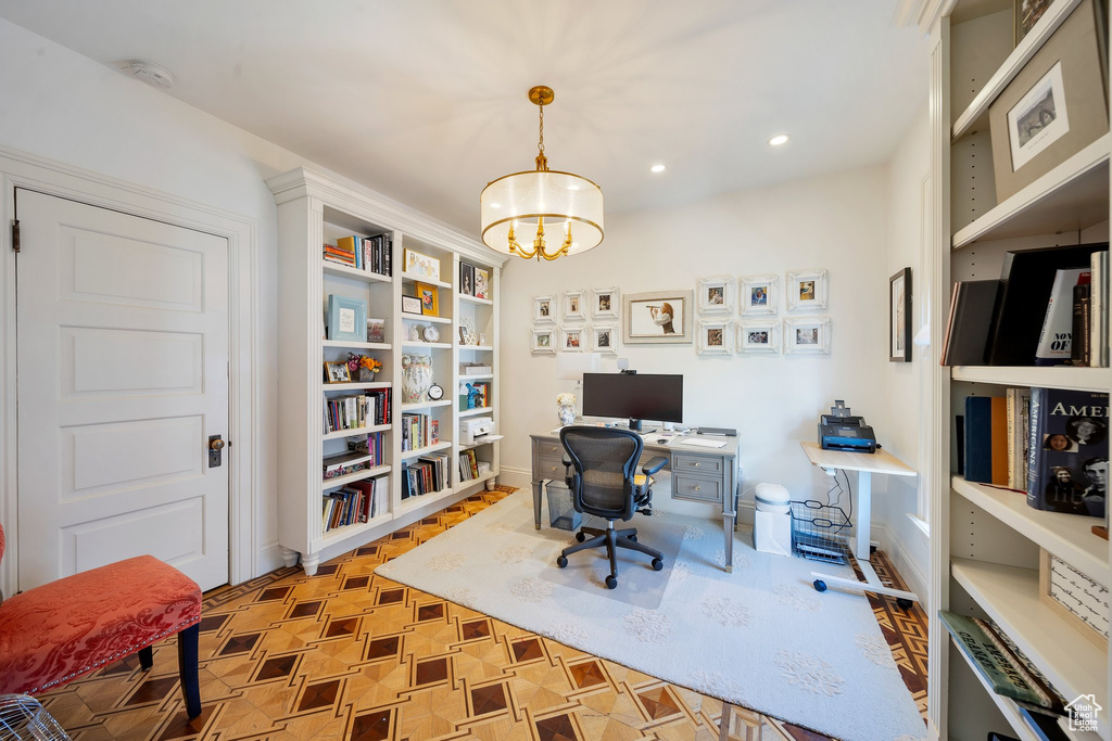 Office space with a notable chandelier